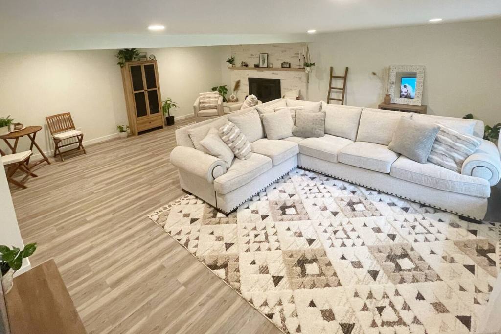 Living room with comfortable sectional and stylish decor at the Creekside Suite in Marysville, WA