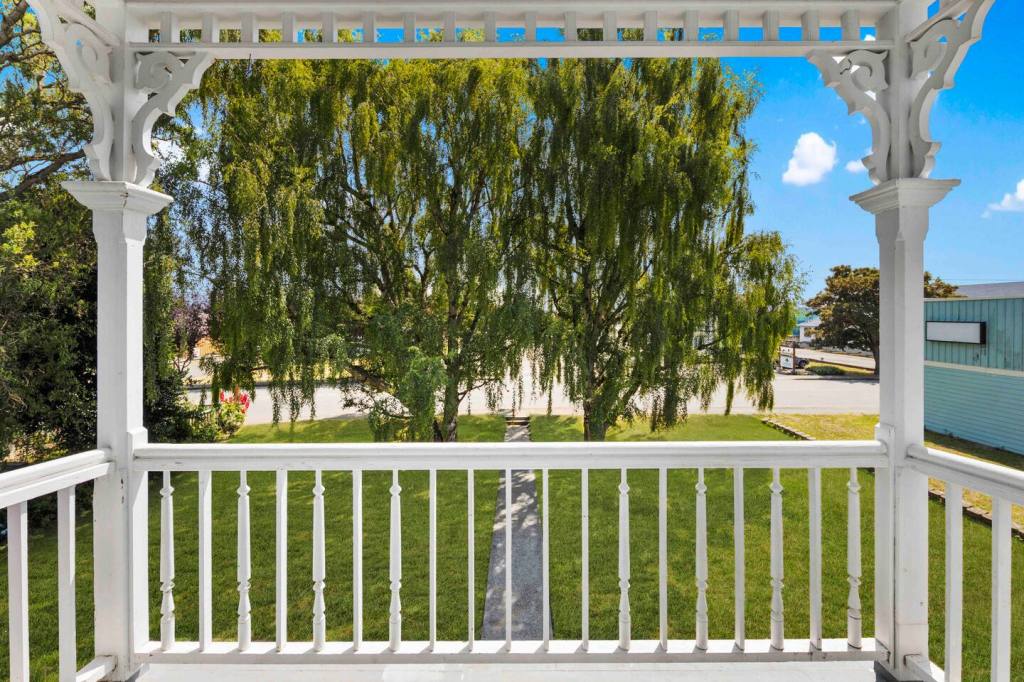 Balcony with Victorian woodwork and willow views
